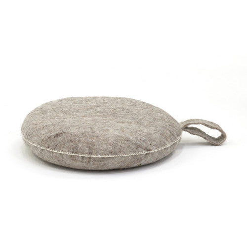 Round gray cushion with a handle on a white background