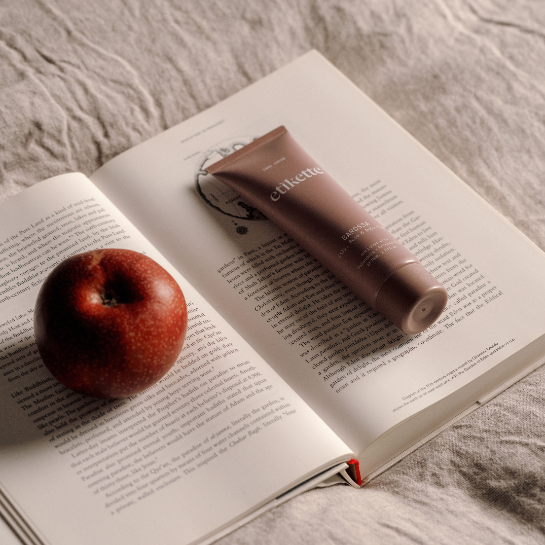 Etikette — hand cream — Barossa in lily, rose & ruby plum — on an open book