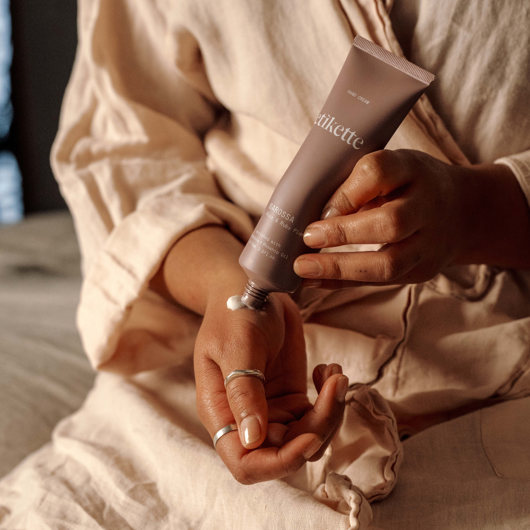 Etikette — hand cream — Barossa in lily, rose & ruby plum — being applied to hands