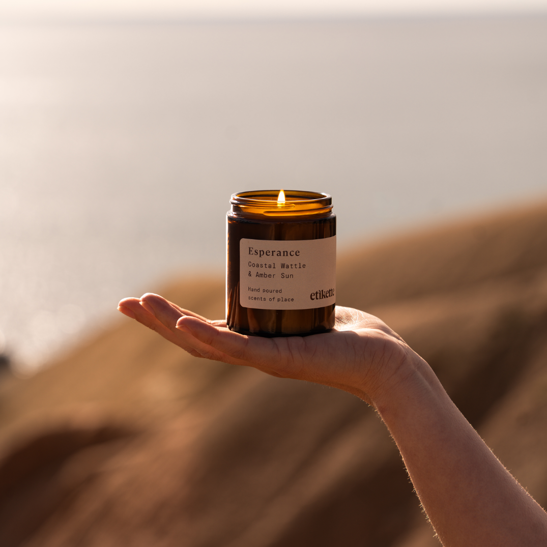 Etikette — soy candle — Esperance in coastal wattle & amber sun — 175ml — small candle held in a hand