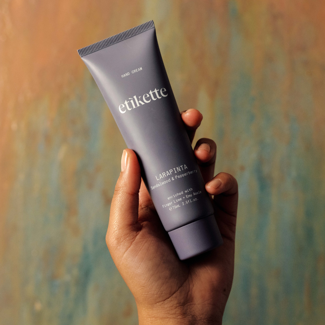 Etikette — hand cream — Larapinta in sandalwood & pepperberry — held in a hand