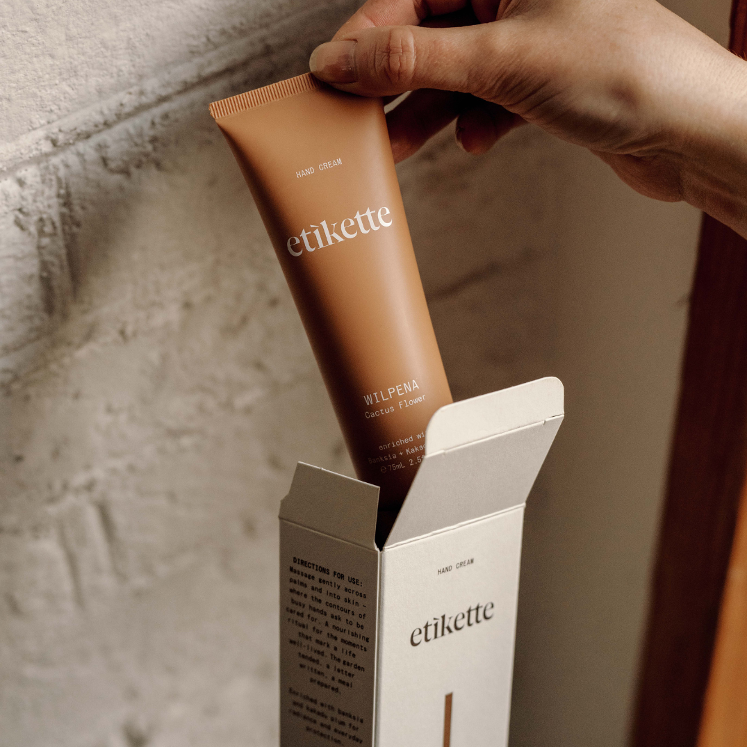 Etikette — hand cream — Wilpena in cactus flower — tube held above its carton