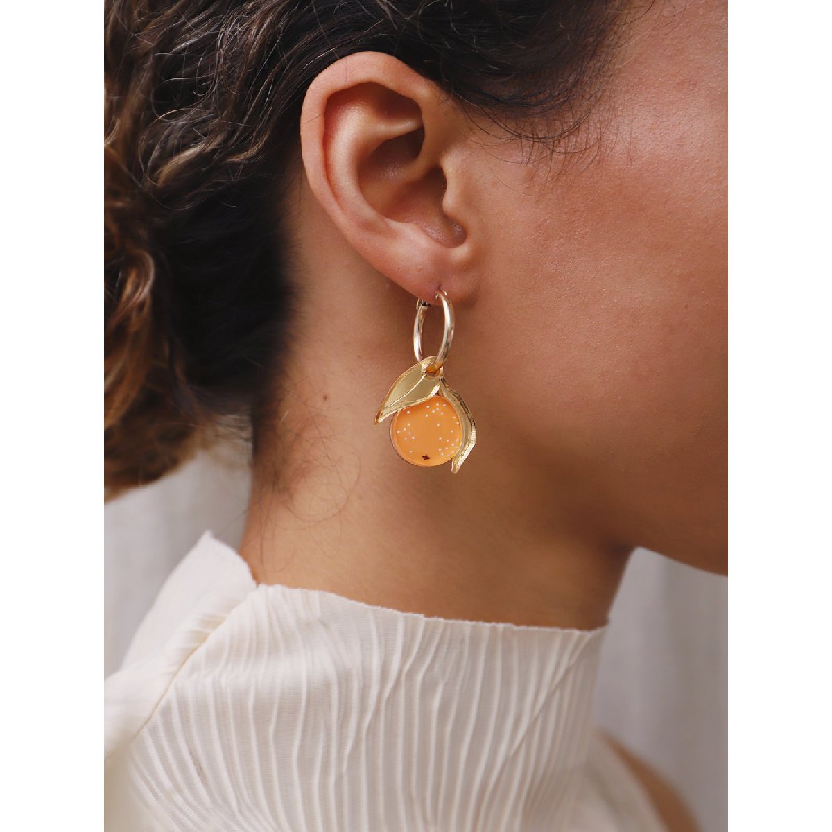 Wolf and Moon | mini orange hoop earrings - model close
