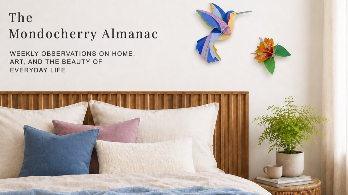 Bedroom with colourful wall art and patterned cushions
