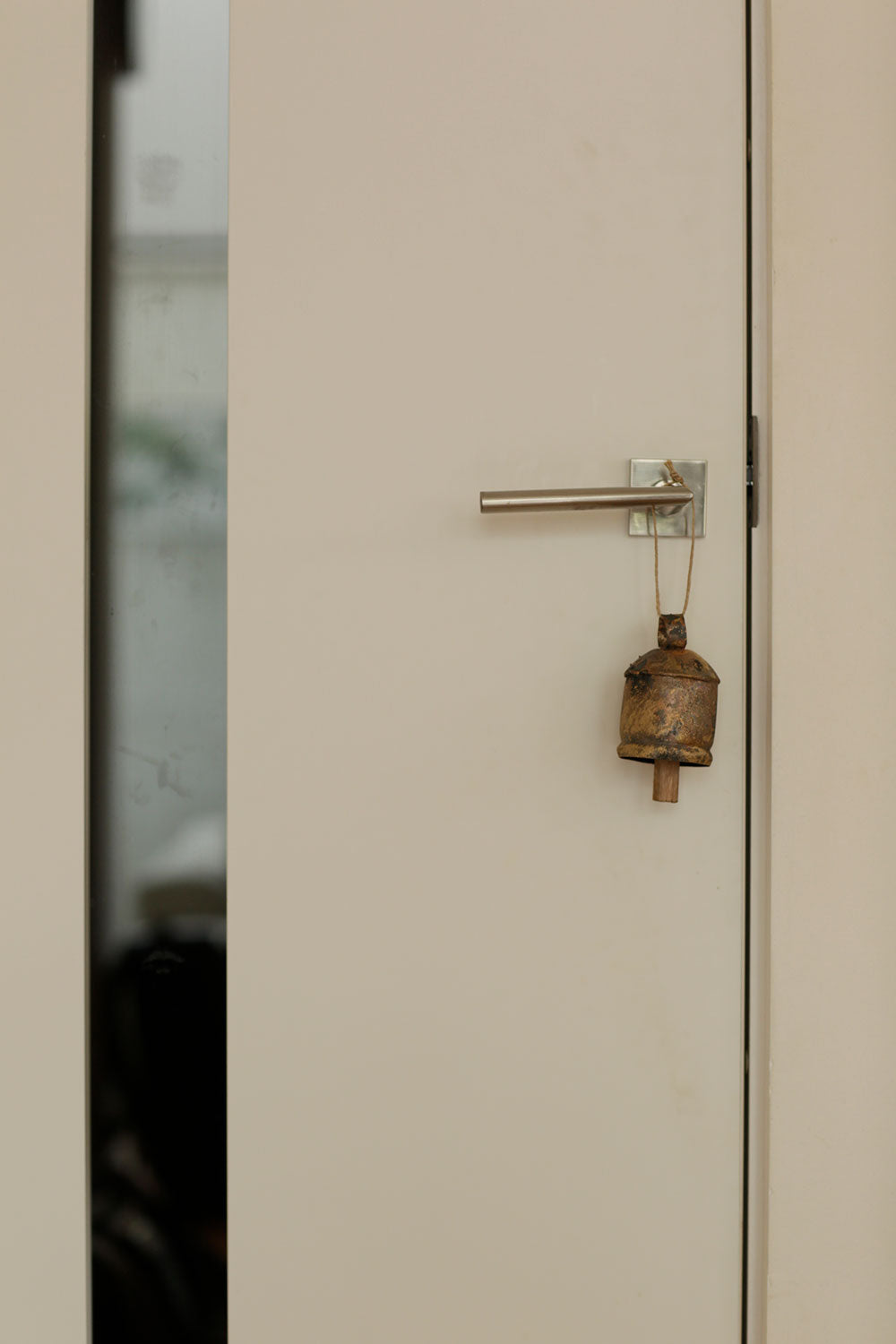 Beige door with a brass handle and lock
