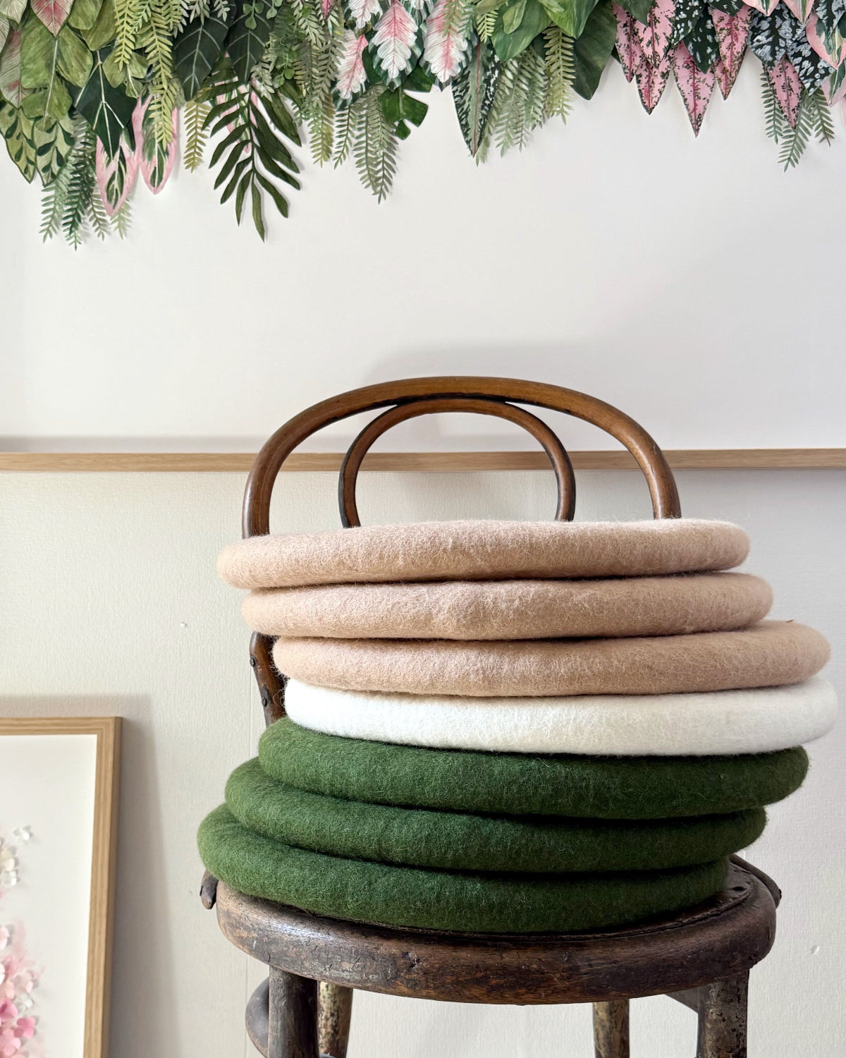 Muskhane felt cushions stacked on chair