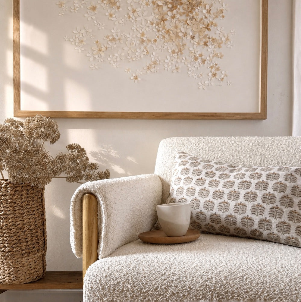 Cozy chair with decorative cushion and mondocherry art.
