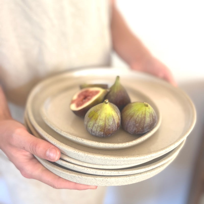 Close-up of figs on stacked ceramic plates.