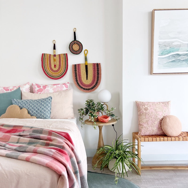 mondocherry cozy bedroom with vibrant wall hangings.