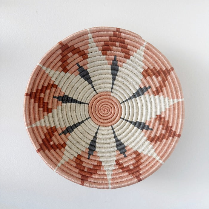 Round woven basket with geometric pattern.