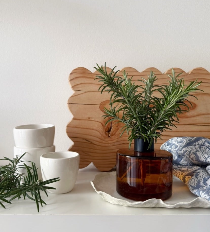 Kitchen corner with herbs in a recycled bottle and a chopping board