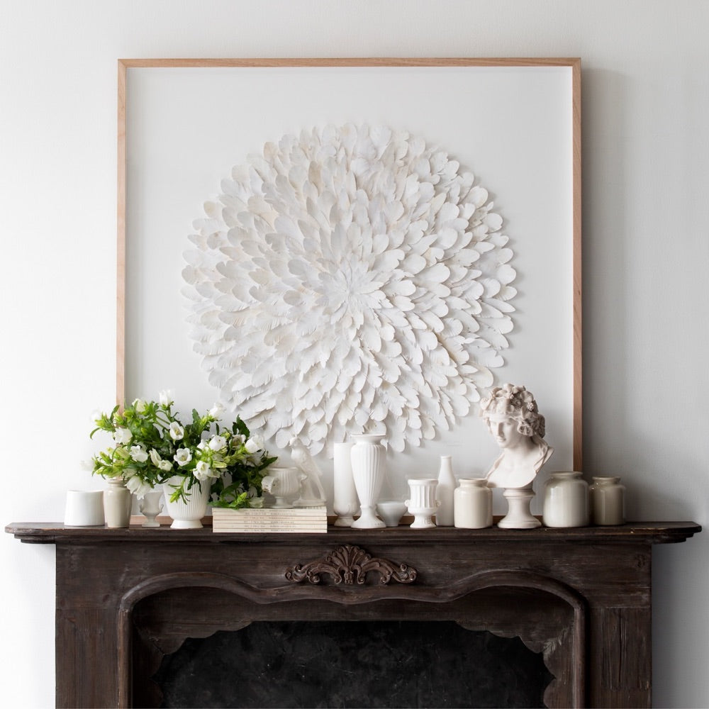 White Mondocherry paper feather artwork above a mantelpiece