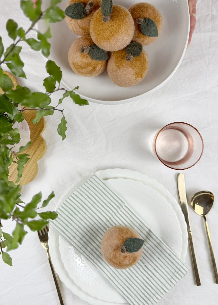 Table setting with colourful felt fruit in a bowl