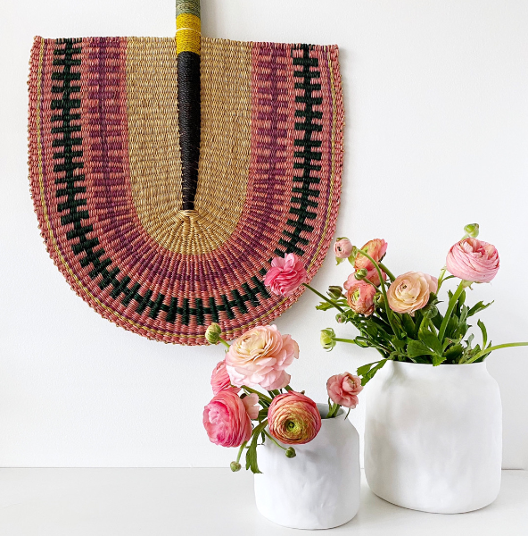 Woven fan with pink flowers in white vases