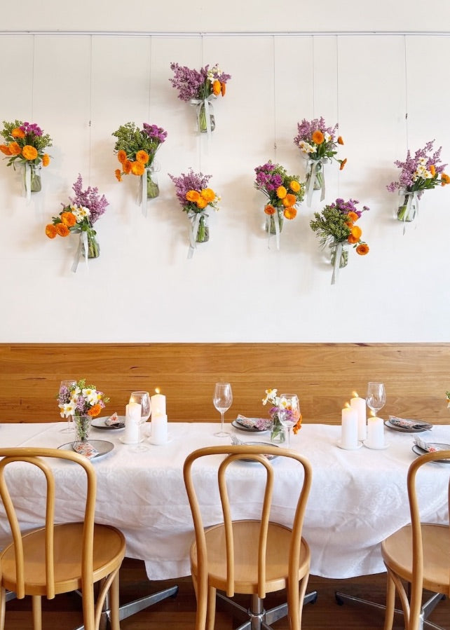 Dining room decorated with flowers in hanging glass jars