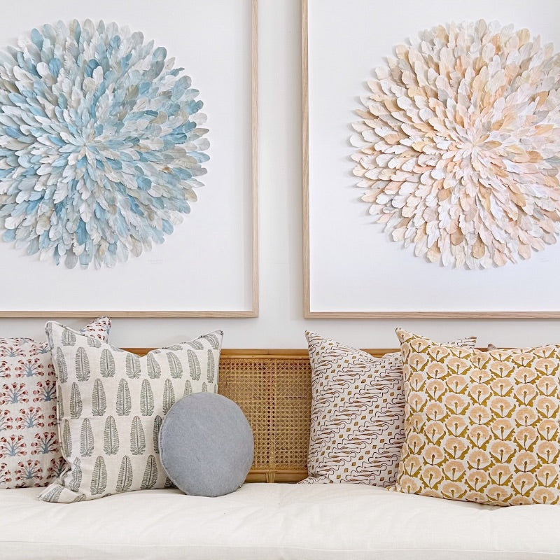 Sofa with patterned cushions and Mondocherry paper feather artworks