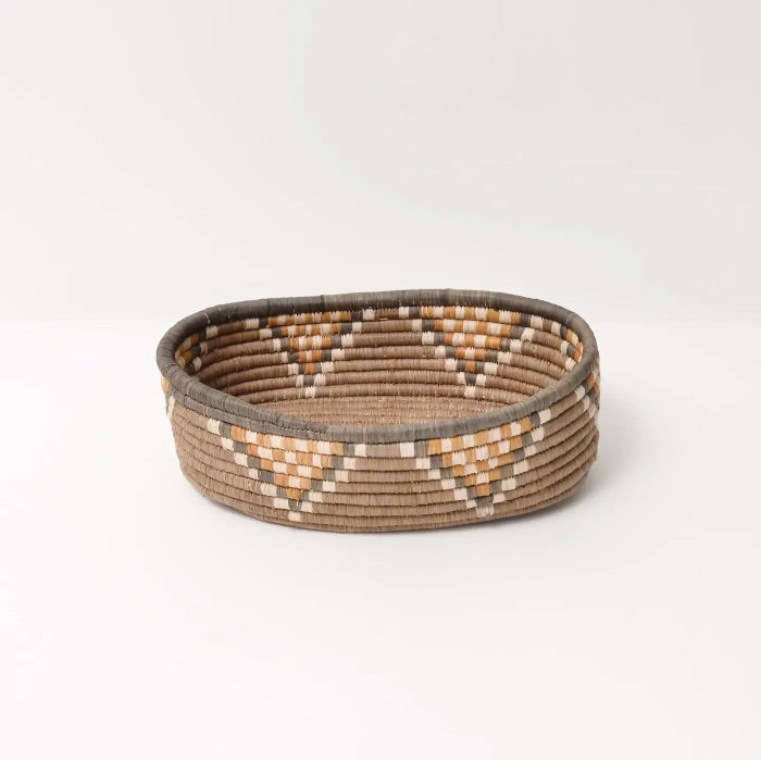 Oval woven basket from Uganda with a geometric pattern