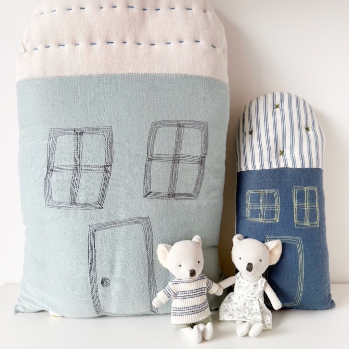 Two toy mice with fabric house cushions.