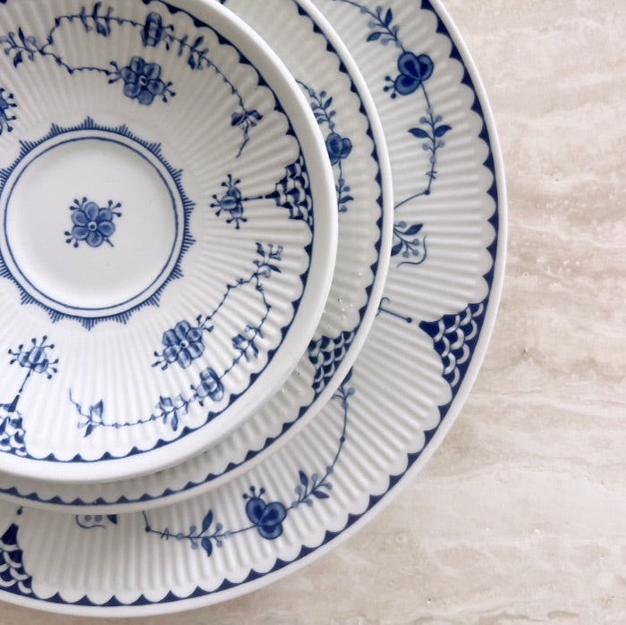 Stacked Danish blue and white floral plates.