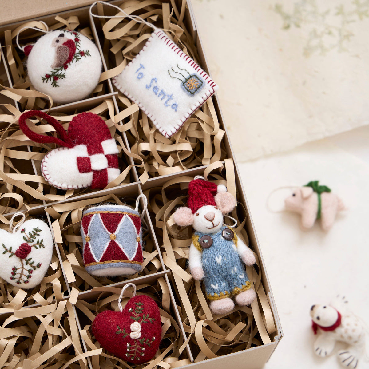 Gry & Sif — Christmas bauble — bird — bird bauble nestled in a gift box with other felt Christmas ornaments