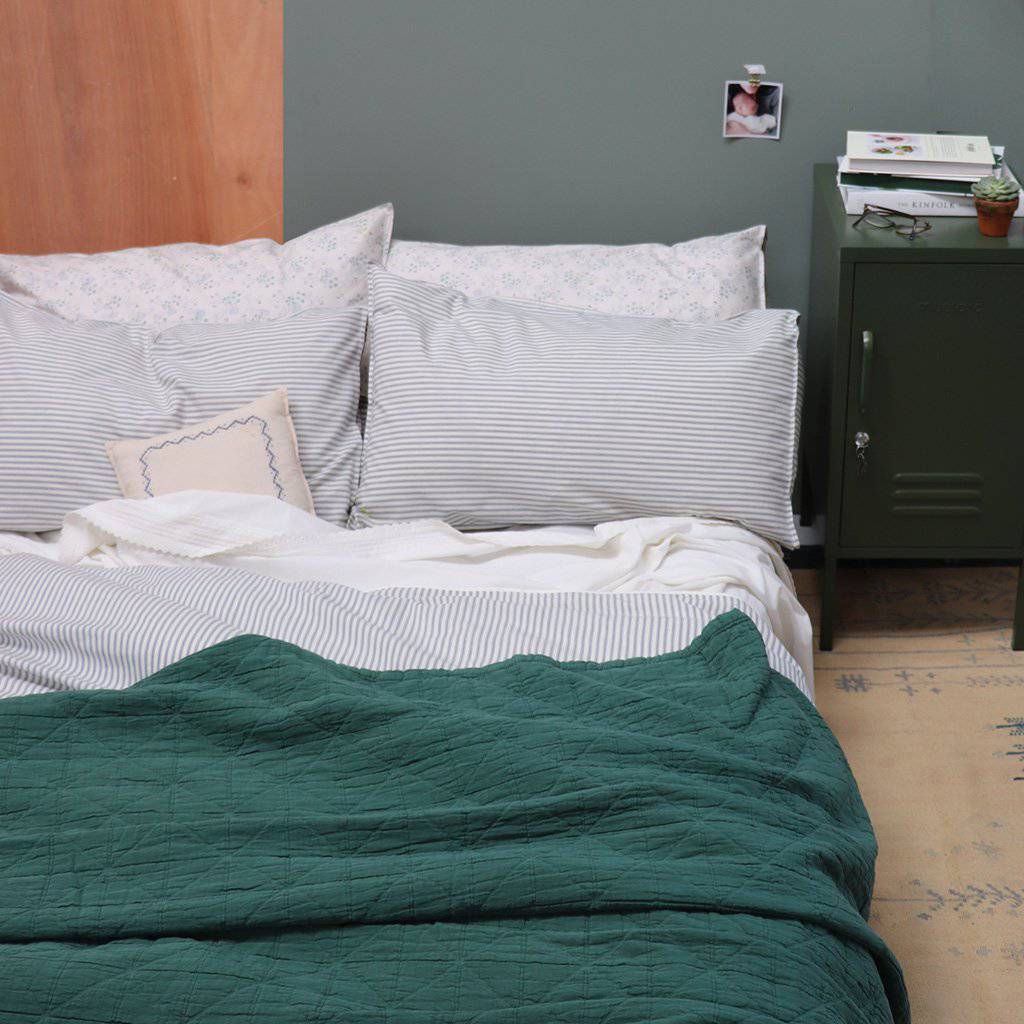 Camomile London | diamond single cotton blanket | green - on bed