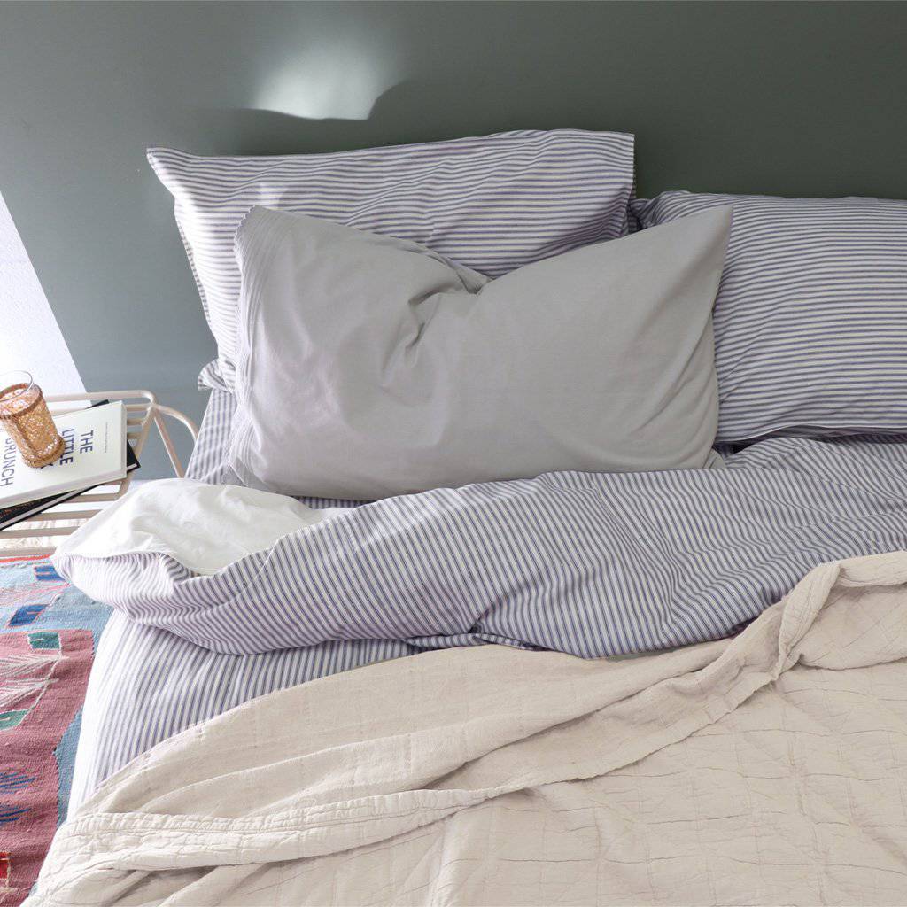 Camomile London | diamond single cotton blanket | natural - on bed
