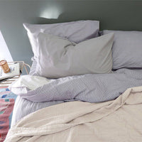 Camomile London | diamond single cotton blanket | natural - on bed