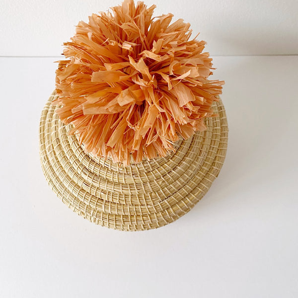 African woven pom pom lidded basket | peach #1 - top