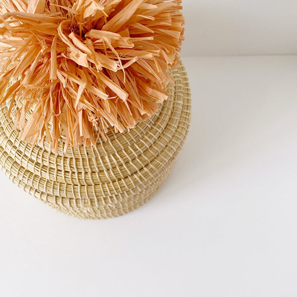African woven pom pom lidded basket | peach #2 - top